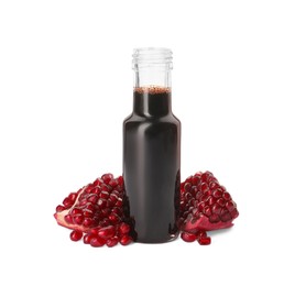 Photo of Bottle of pomegranate sauce and fresh ripe fruit on white background