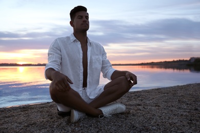 Photo of Man near river at sunset, space for text. Nature healing power