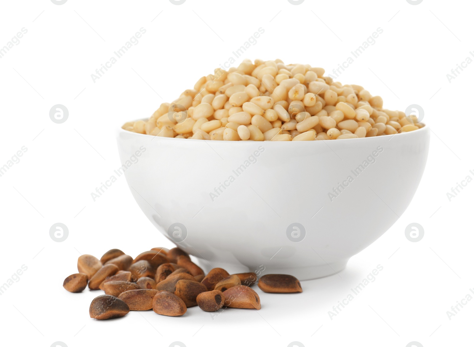 Photo of Bowl with pine nuts on white background