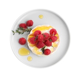 Photo of Brie cheese served with raspberries and honey isolated on white, top view