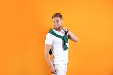 Photo of Young man with trendy hairstyle on color background