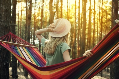 Photo of Woman resting in hammock outdoors on summer day