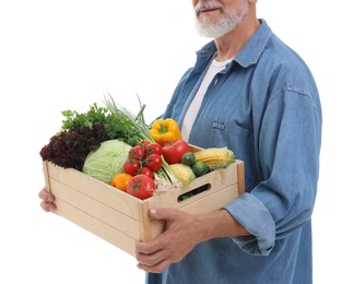 Photo of Harvesting season. Farmer holding wooden crate with vegetables on white background, closeup