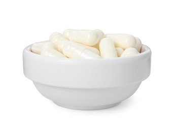 Photo of Vitamin capsules in bowl isolated on white. Health supplement