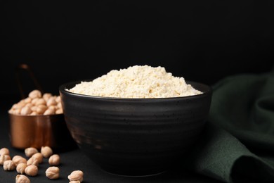 Photo of Chickpea flour in bowl and seeds on black table