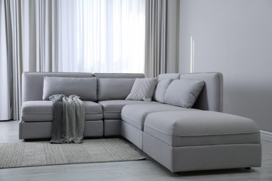 Photo of Large grey sofa in living room. Interior design