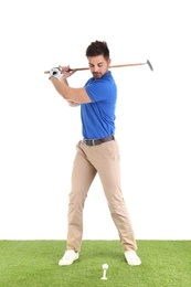 Photo of Young man playing golf on course against white background