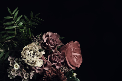 Beautiful bouquet of different flowers on black background, space for text. Floral card design with dark vintage effect