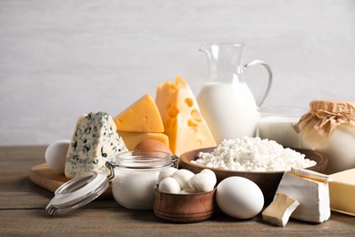 Different delicious dairy products on wooden table