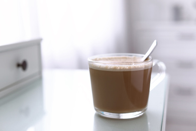 Photo of Delicious morning coffee on white table indoors. Space for text