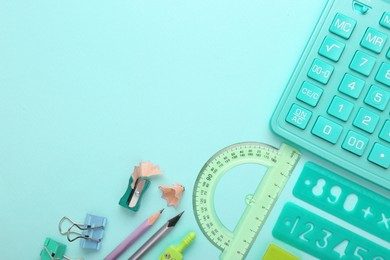 Photo of Calculator and stationery on light background, flat lay. Space for text