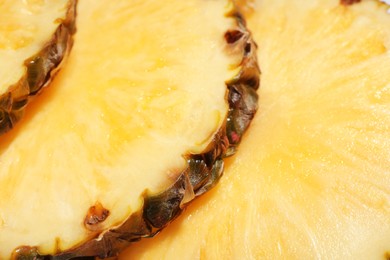 Photo of Slices of tasty ripe pineapple as background, closeup