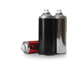 Photo of Different cans of spray paints on white background