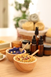Photo of Dry flowers on wooden table indoors, space for text. Spa time