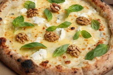 Photo of Delicious cheese pizza with walnuts and basil as background, closeup
