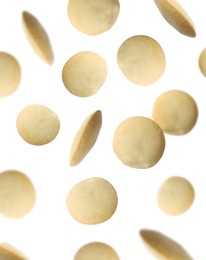 Image of Many lentils falling on white background. Vegan diet 