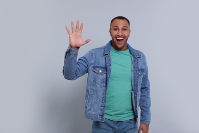Photo of Man giving high five on grey background, space for text