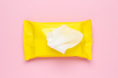 Photo of Wet wipes flow pack on pink background, top view