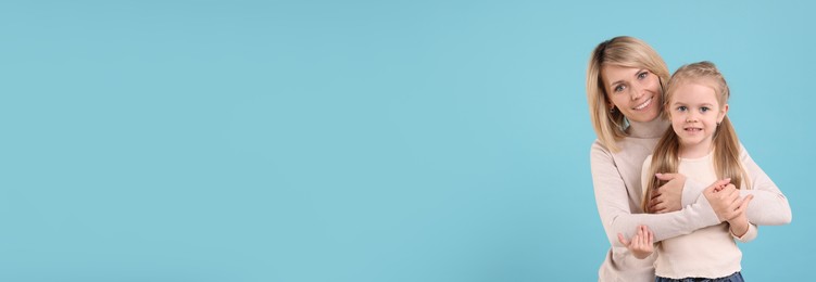 Image of Happy mother and daughter on light blue background, space for text. Banner design