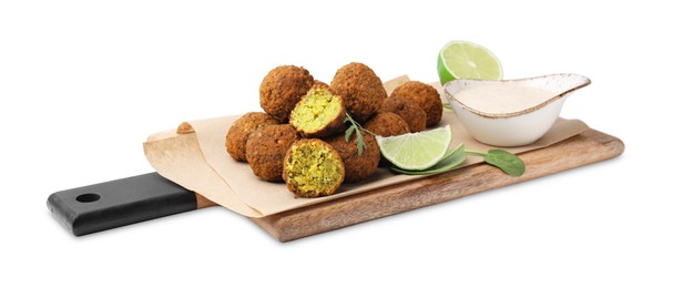 Photo of Delicious falafel balls, sauce, herbs and lime isolated on white