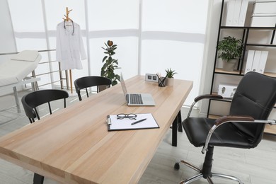 Photo of Modern medical office interior with doctor's workplace