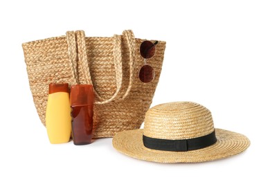 Photo of Stylish straw hat, beach bag, cosmetic products and sunglasses on white background