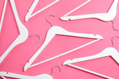 Photo of Flat lay composition with empty hangers on color background