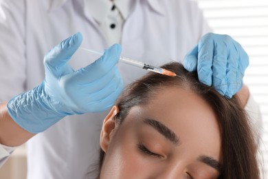 Photo of Trichologist giving injection to patient, closeup view