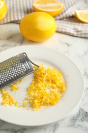 Photo of Lemon zest and fresh fruits on white marble table