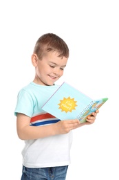 Photo of Cute little boy reading book on white background