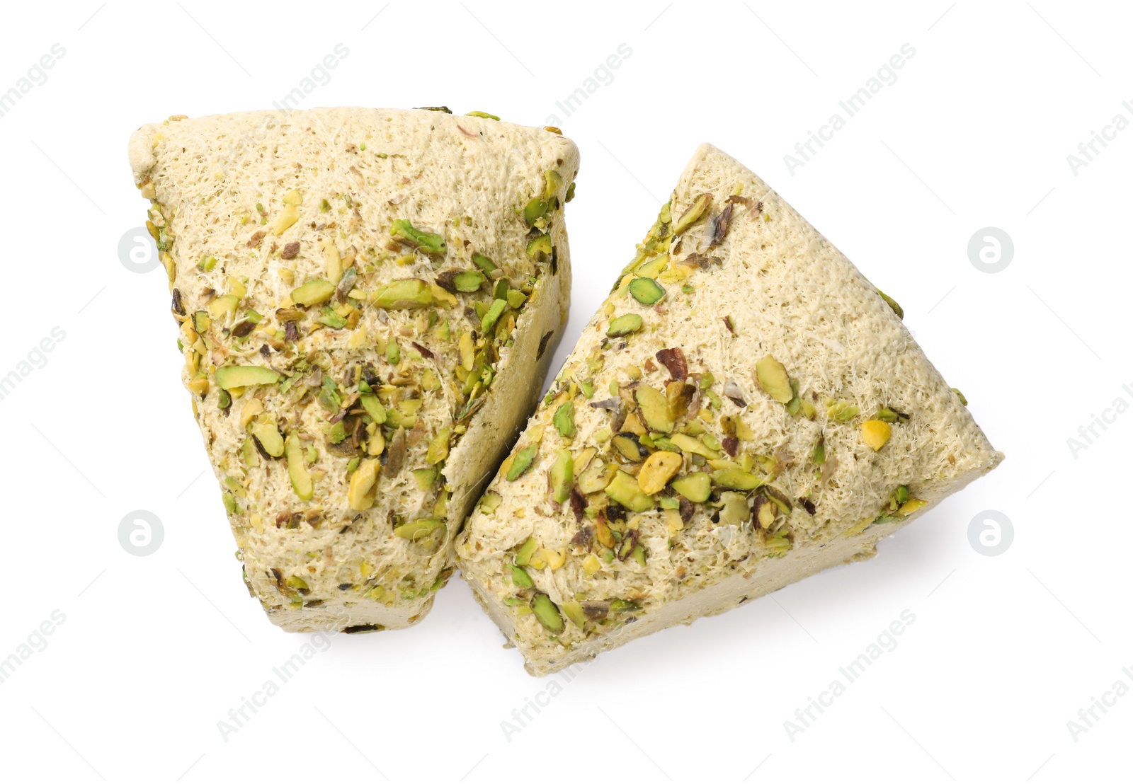 Photo of Pieces of tasty halva with pistachios on white background, top view