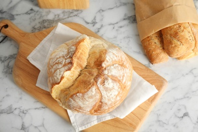 Composition with fresh bread on marble table, flat lay