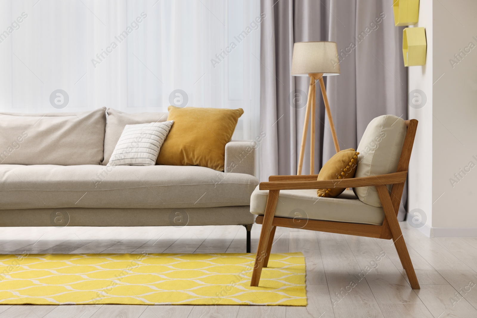 Photo of Spring atmosphere. Comfy sofa, lamp and armchair in room