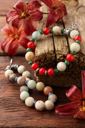 Stylish presentation of beautiful bracelets with gemstones on wooden table