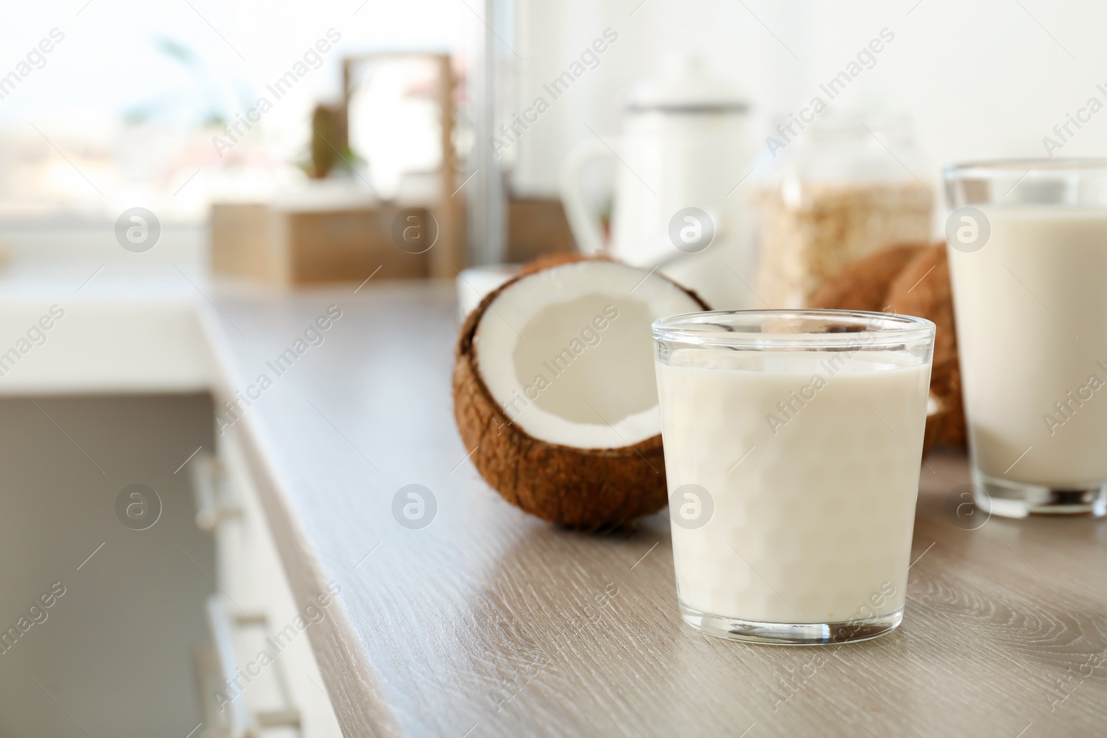 Photo of Glass with coconut milk on kitchen table