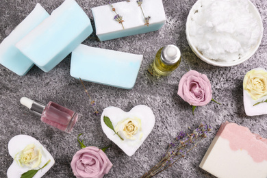 Photo of Flat lay composition with natural handmade soap and ingredients on grey stone table