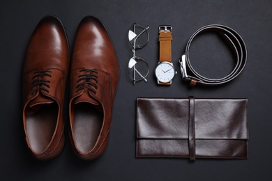 Men set with stylish accessorizes on black background, flat lay