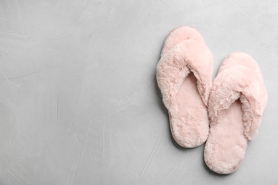 Photo of Pair of soft slippers on light grey background, flat lay. Space for text