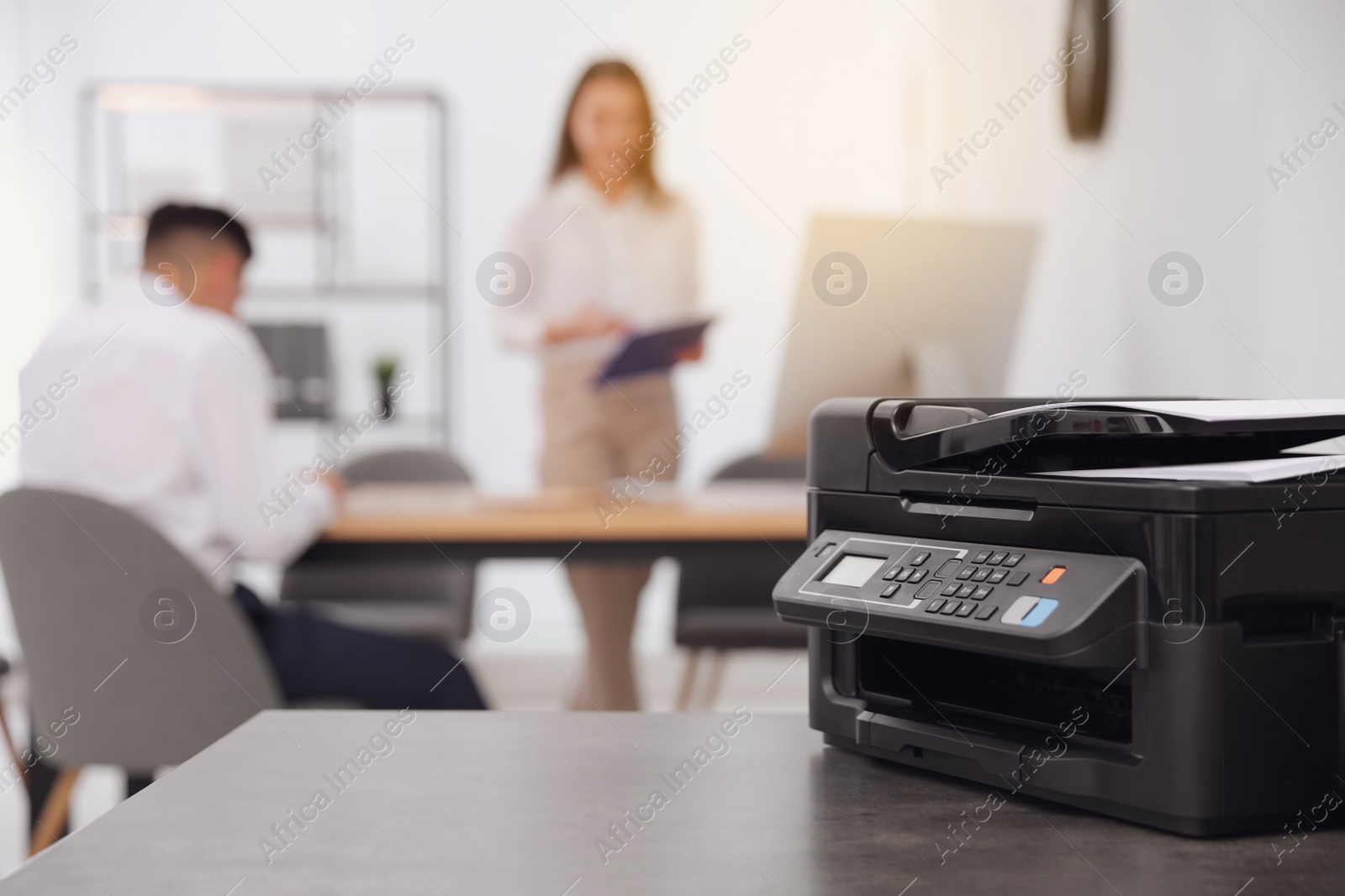 Photo of New modern printer on table in office. Space for text