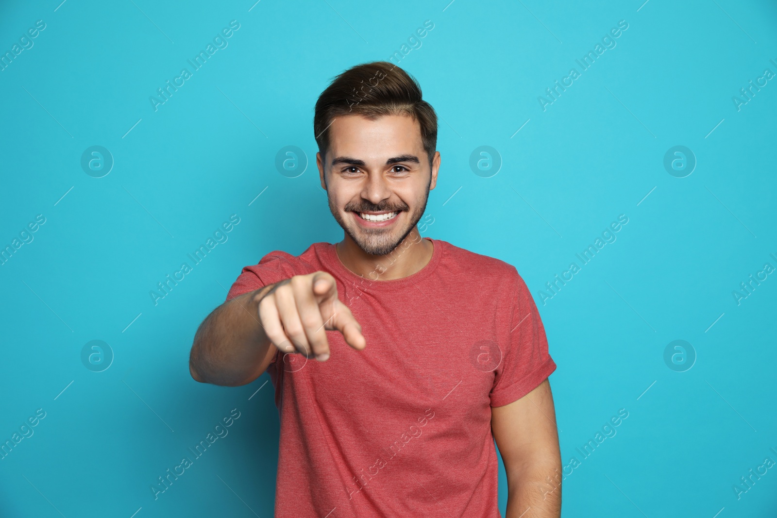 Photo of Handsome young man laughing against color background