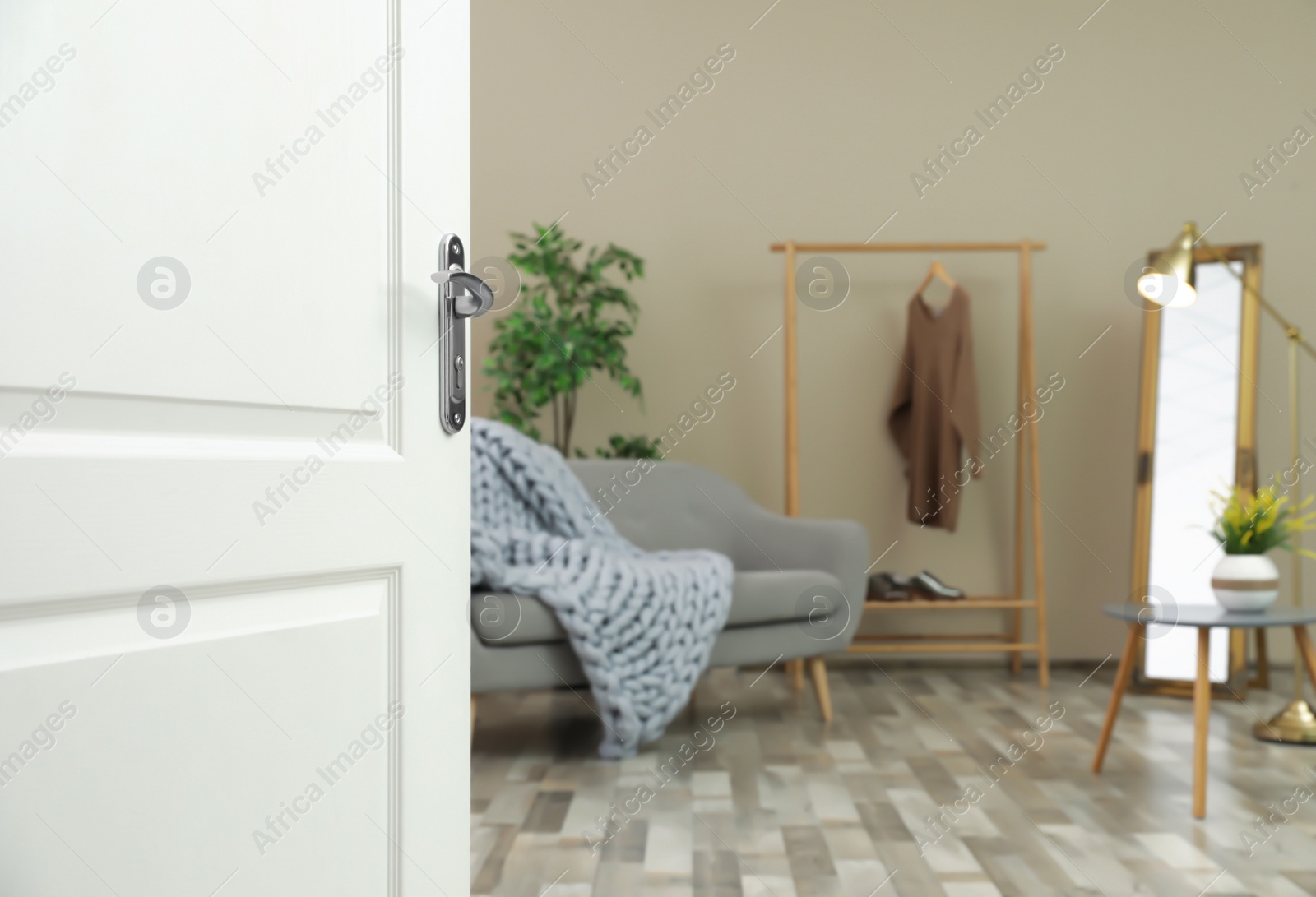 Photo of Stylish room interior, view through open door