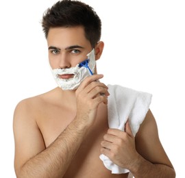 Photo of Handsome young man shaving with razor on white background