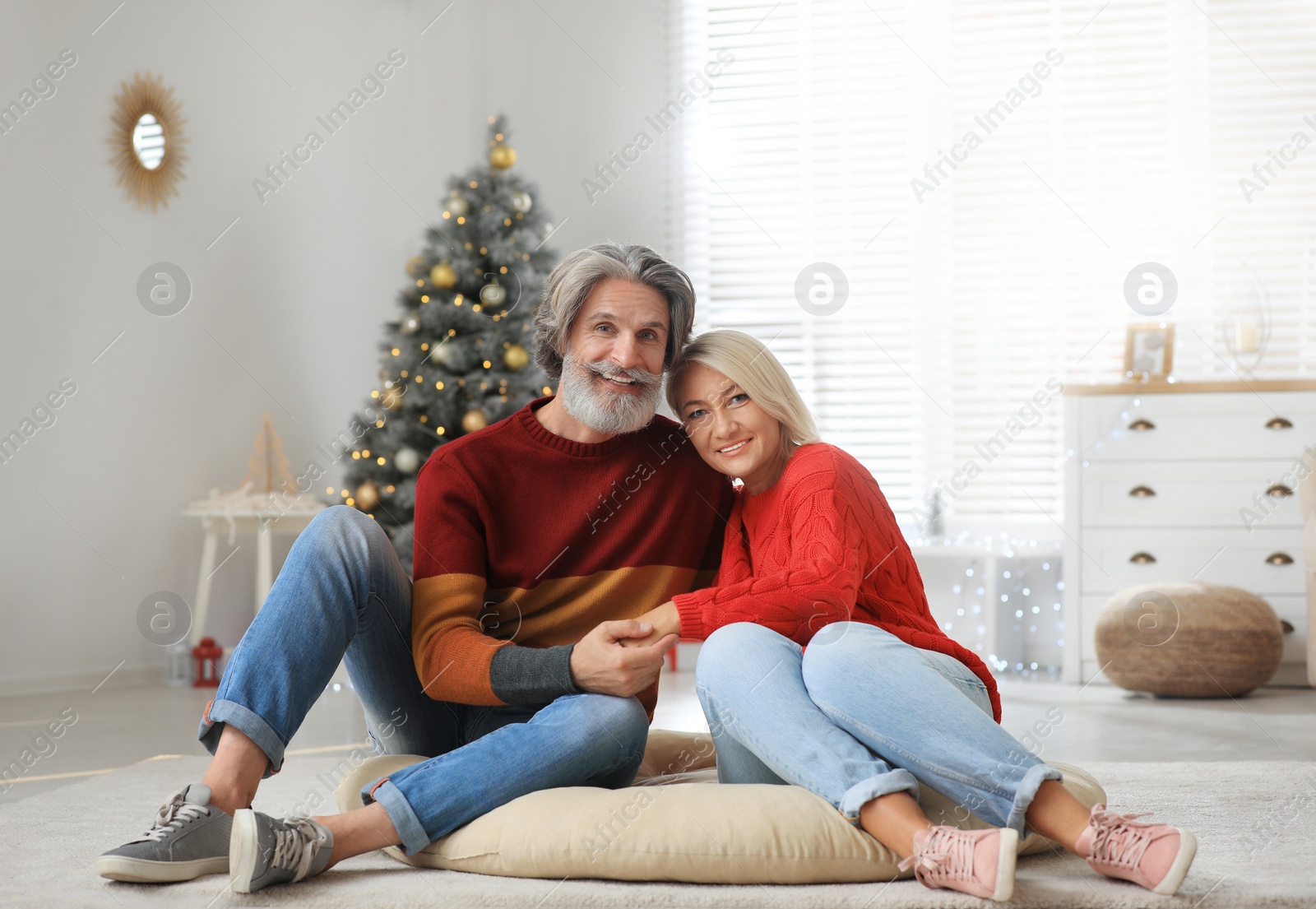 Photo of Happy mature couple celebrating Christmas at home