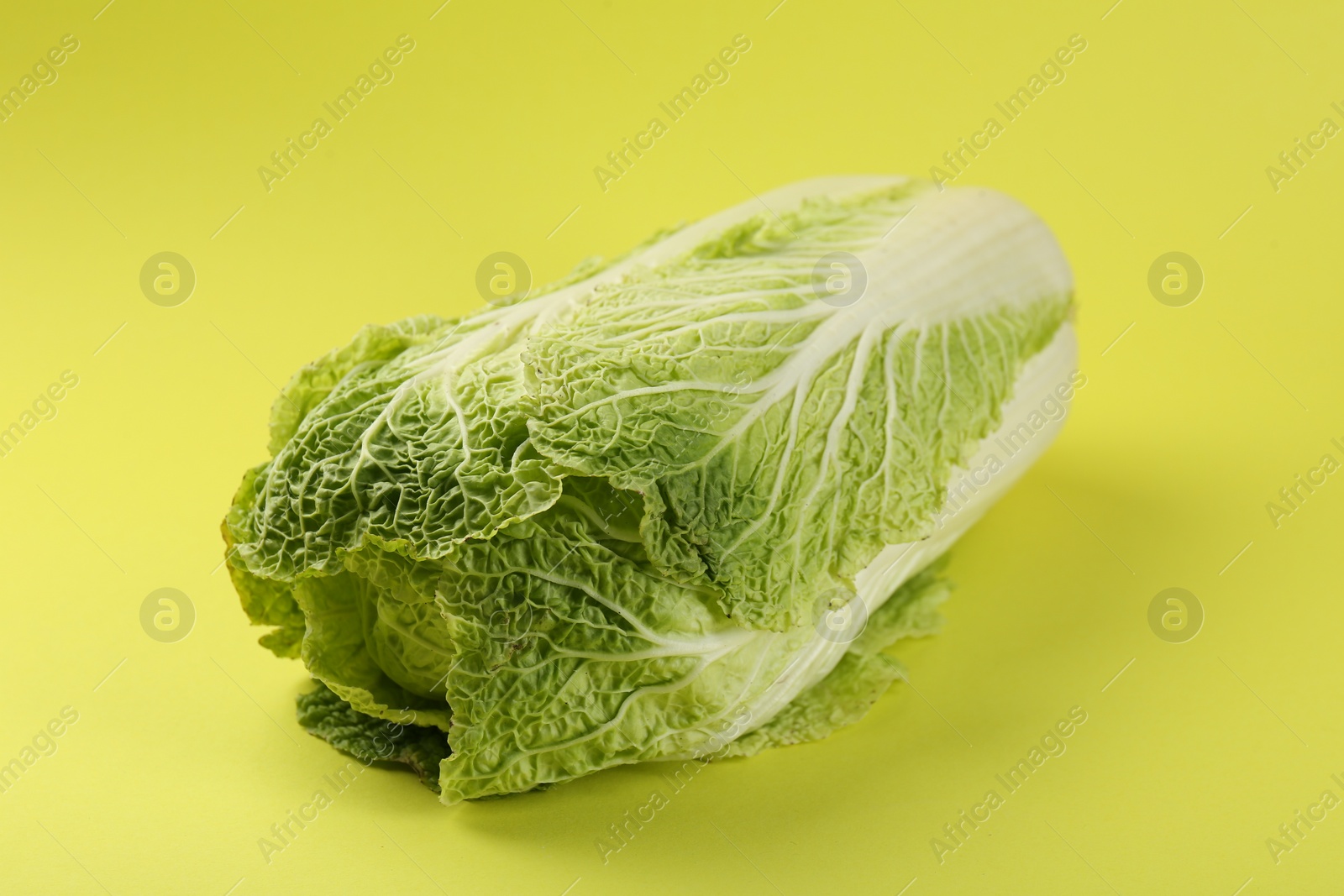 Photo of Fresh ripe Chinese cabbages on pale yellow background, closeup