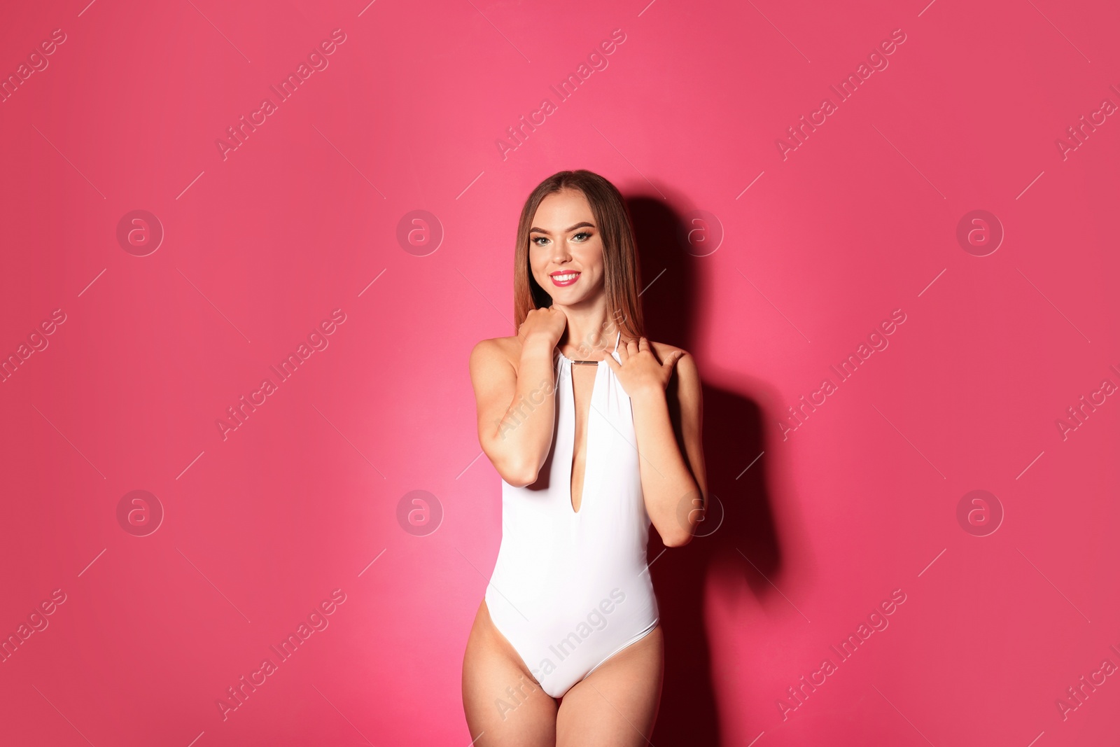 Photo of Pretty sexy woman with beautiful slim body in stylish bikini on color background