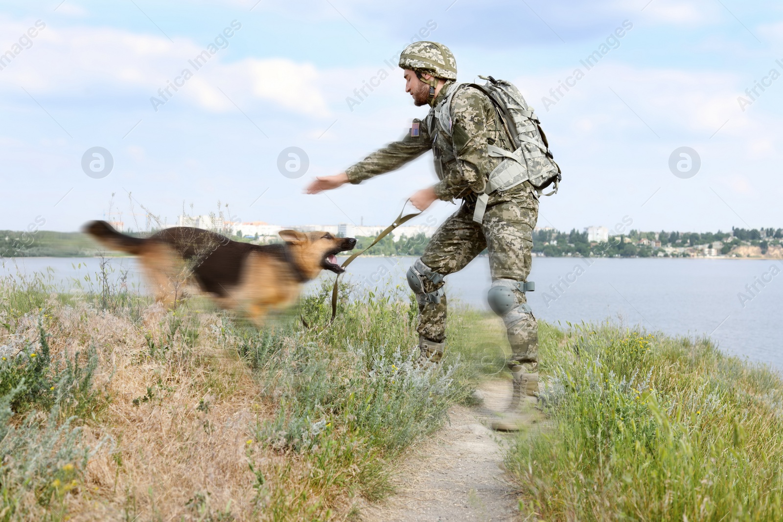 Image of Man in military uniform with German shepherd dog outdoors