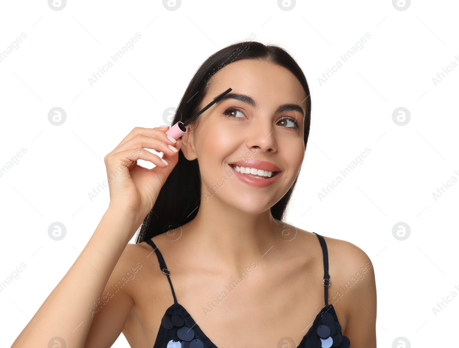 Photo of Beautiful young woman applying mascara on white background