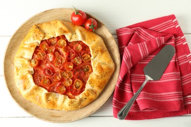 Tasty tomato galette (Caprese galette) on white wooden table, top view