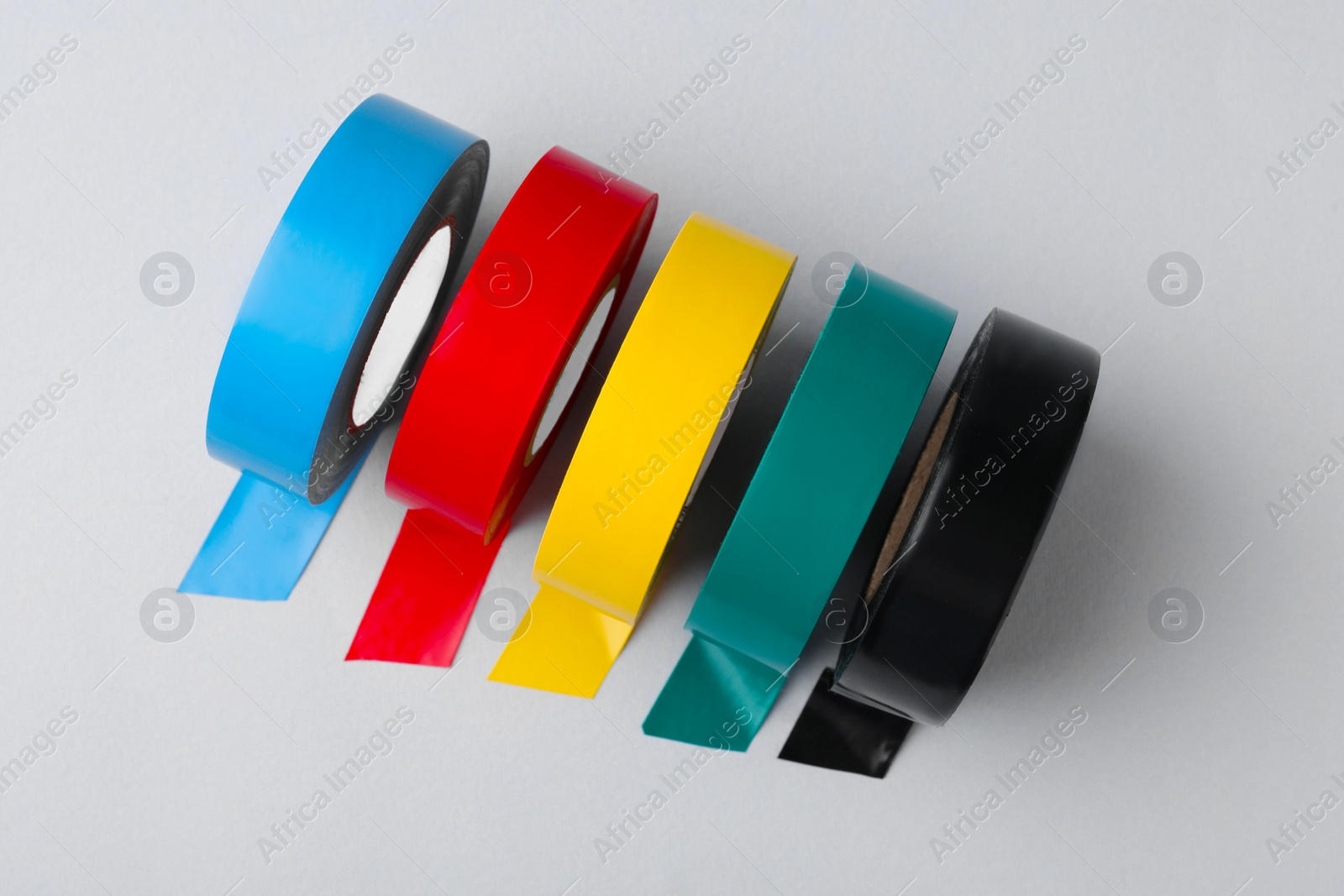 Photo of Colorful insulating tapes on white background, flat lay