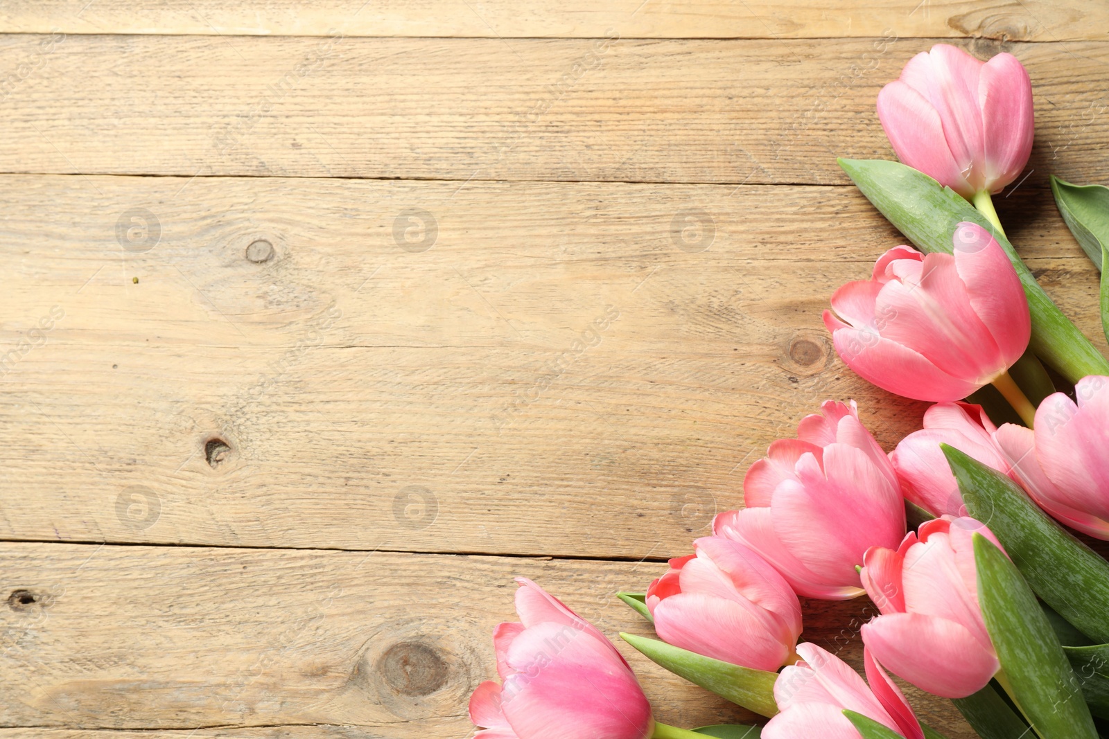 Photo of Happy Mother's Day. Beautiful pink tulips on wooden table, flat lay. Space for text